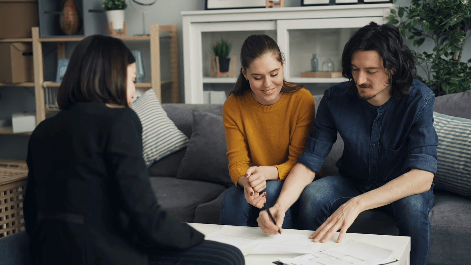 Couple reviewing mortgage and protection documents with an adviser